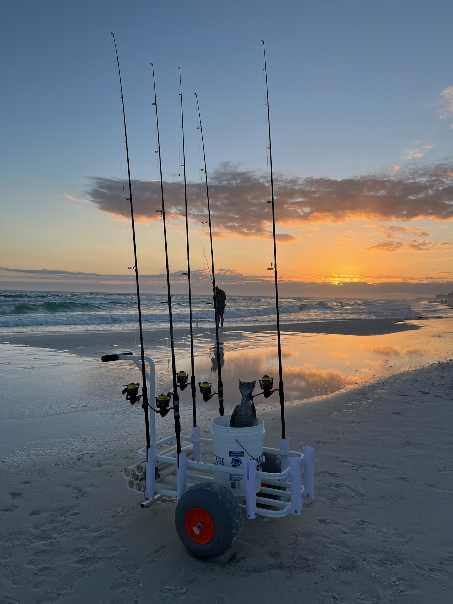 Gulf Coast Tackle Runner fishing cart loaded with gear at sunset